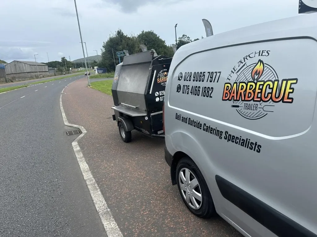 The Arches catering van towing the BBQ trailer