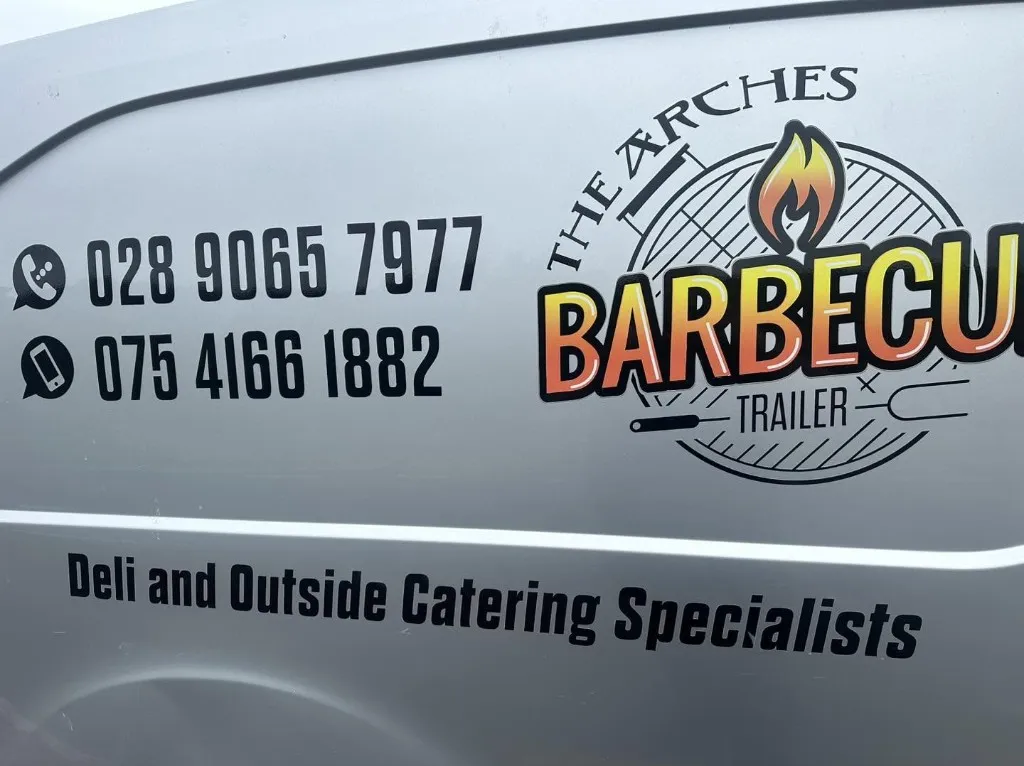 The Arches Barbecue Trailer logo and contact details on the van